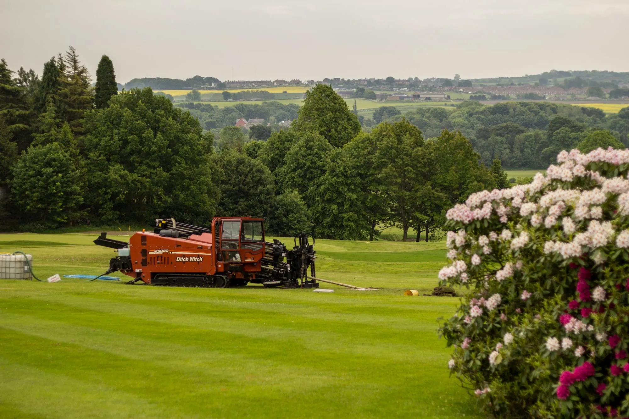 A directional drilling rig working in green parkland with minimal ground disturbance