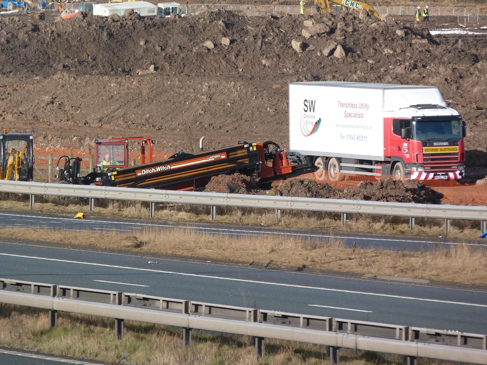 S.W. Directional Drilling lorry and rig set up on a verge beside a live motorway