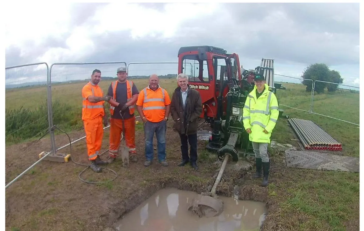 The S.W.Directional Drilling crew with the Ditch Witch rig at the completed Pawlett Hams crossing, the reamer sitting in the drilling fluid in the pit