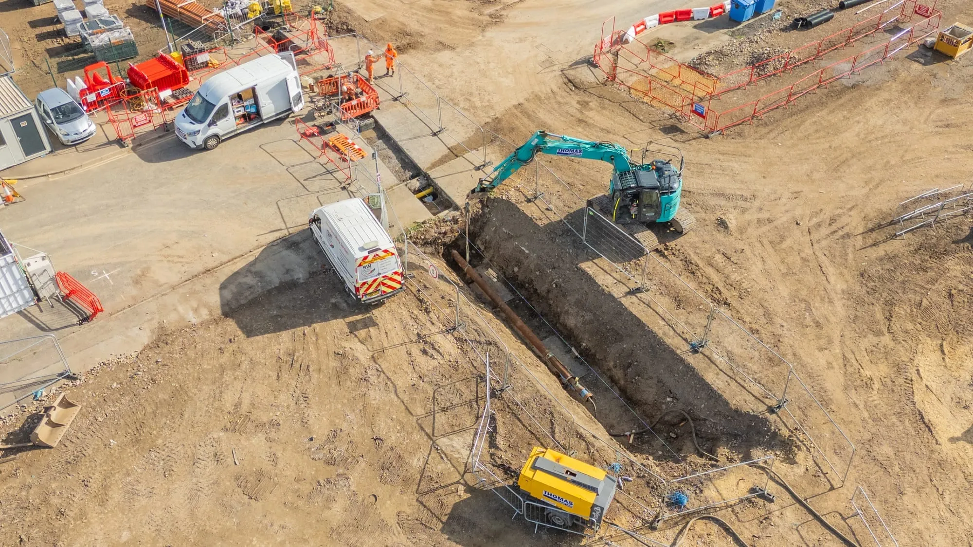 Trenchless crossing installation beneath a retaining wall